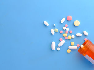 Pills spilled on a blue background