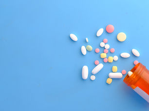 Pills spilled on a blue background