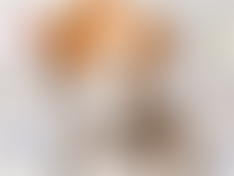 tan and white puppy leaning down to eat dog food out of a metal bowl with three clouds with question marks in the middle