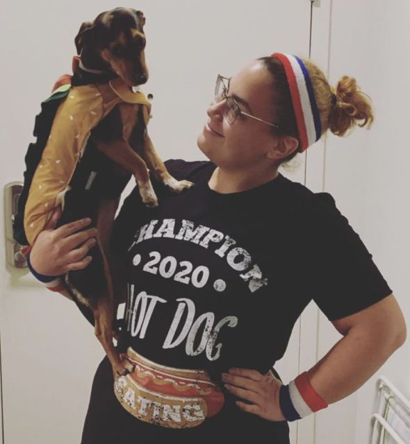 Portrait of Francia and her dog Enid with hot dog costumes on