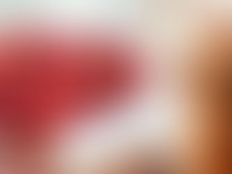orange cat looking at a bowl of cherries